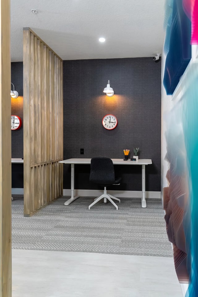 Desk with chair and red clock study area at The Collective at Columbia in Columbia Student Accommodation