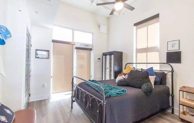 Bed with pillows and blanket closet bedroom at Midtown Auburn in Auburn Student Accommodation
