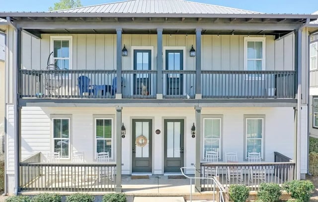 Balcony with chairs white chairs on porch exterior at Midtown Auburn in Auburn Student Accommodation