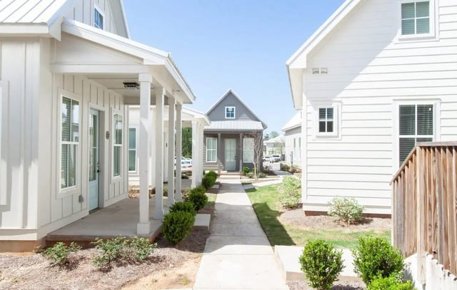 White houses with blue doors pathway exterior at Midtown Auburn in Auburn Student Accommodation
