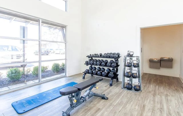 Dumbbells kettlebells bench yoga mat gym at Midtown Auburn in Auburn Student Accommodation