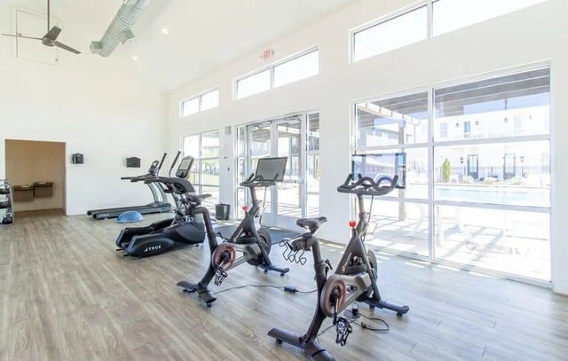 Exercise bikes treadmills and pool view Fitness Area at Midtown Auburn in Auburn Student Accommodation