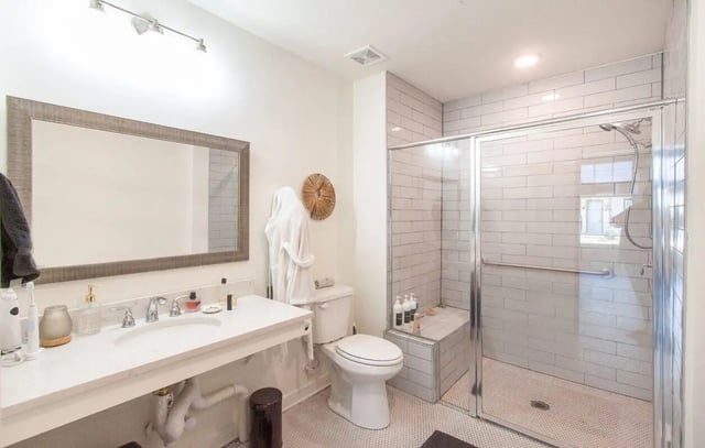 Sink toilet shower with glass door bathroom at Midtown Auburn in Auburn Student Accommodation
