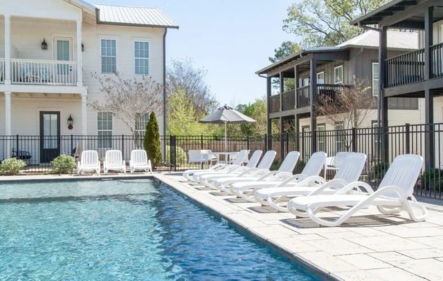 Poolside lounge chairs and umbrella exterior at Midtown Auburn in Auburn Student Accommodation