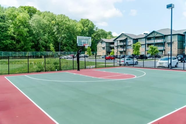 Basketball court with apartment buildings and trees exterior at The Waverly in Newark Student Accommodation