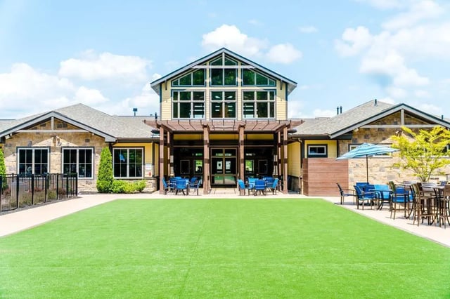 Building with blue chairs and tables outdoors exterior at The Waverly in Newark Student Accommodation