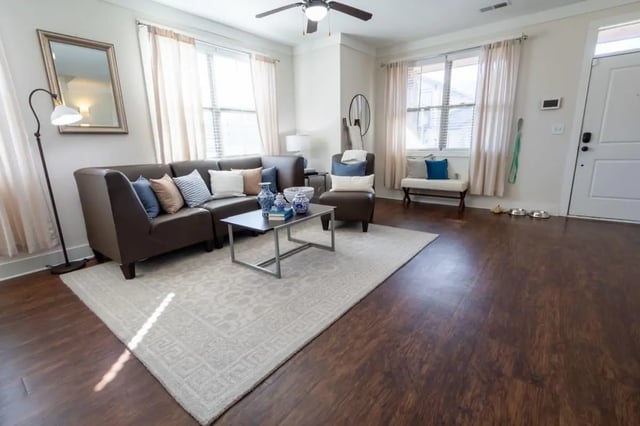 Brown sectional sofa coffee table and mirror living room at The Waverly in Newark Student Accommodation