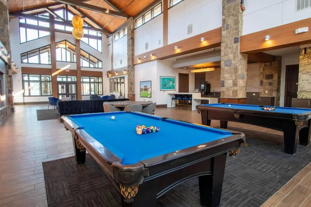 Two blue pool tables with billiard balls playing area at The Waverly in Newark Student Accommodation