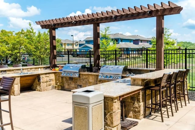Outdoor kitchen with grills sinks and bar seating exterior at The Waverly in Newark Student Accommodation
