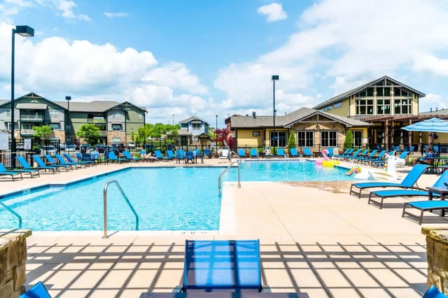 Pool with lounge chairs and inflatables exterior at The Waverly in Newark Student Accommodation