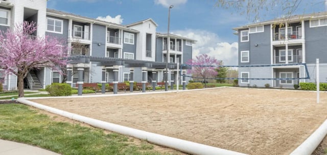 Volleyball court with apartment buildings exterior at The Connection at Lawrence in Lawrence Student Accommodation