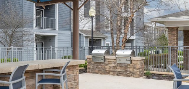 Two grills and counter with chairs playing area at The Connection at Lawrence in Lawrence Student Accommodation