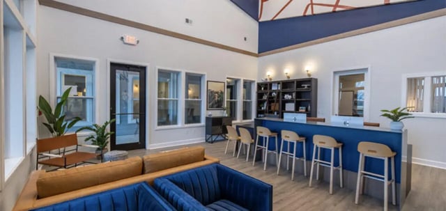 Seating area with bar and stools common room at The Connection at Lawrence in Lawrence Student Accommodation