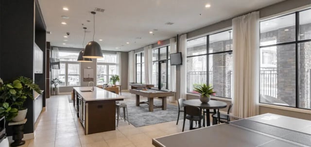 Kitchen island pool tables dining area and ping pong table lounge area at The Connection at Lawrence in Lawrence Student Accommodation