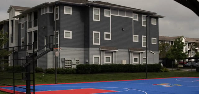 Building with basketball hoop and court exterior at The Connection at Lawrence in Lawrence Student Accommodation