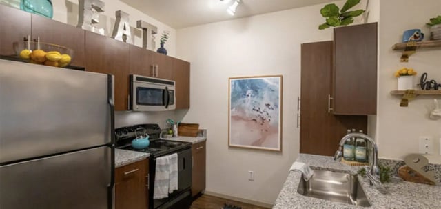 Stainless steel refrigerator stove microwave kitchen kitchen at The Connection at Lawrence in Lawrence Student Accommodation
