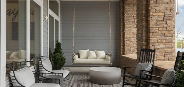 Chairs swing and coffee table exterior living room at The Connection at Lawrence in Lawrence Student Accommodation