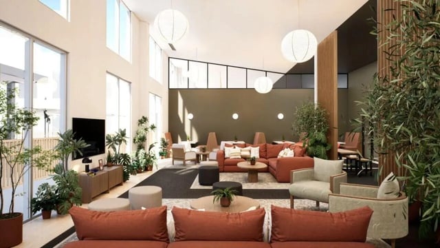 Sofa chairs tables and plants living room at Proxi Lawrence Apartments in Lawrence Student Accommodation