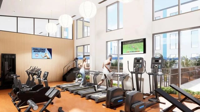 Treadmills ellipticals people exercising gym playing area at Proxi Lawrence Apartments in Lawrence Student Accommodation