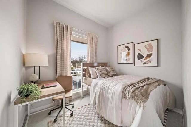 Bed desk lamp artwork and rug bedroom at Proxi Lawrence Apartments in Lawrence Student Accommodation