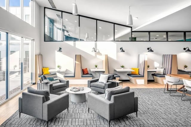 Modern lounge area with booths chairs and tables living room at Proxi Lawrence Apartments in Lawrence Student Accommodation