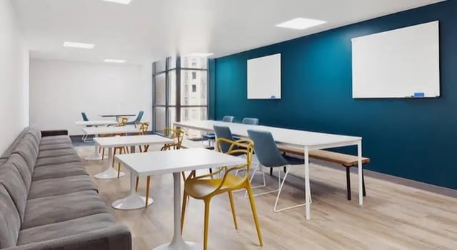 Gray sofa white tables blue chairs whiteboard communal area at SoCam 290 Apartments in New Brunswick Student Accommodation