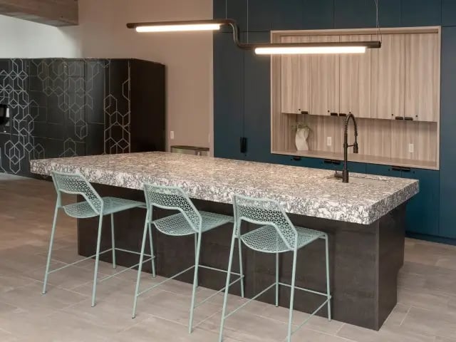 Modern kitchen island with mint chairs kitchen at SoCam 290 Apartments in New Brunswick Student Accommodation
