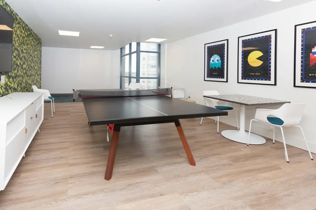 Ping pong table white sideboard game posters entertainment area at SoCam 290 Apartments in New Brunswick Student Accommodation