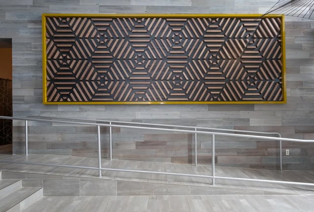 Geometric wall art and ramp with railings hallway at SoCam 290 Apartments in New Brunswick Student Accommodation
