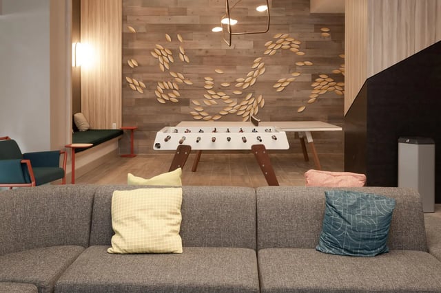 Foosball table couch pillows and seating area lounge at SoCam 290 Apartments in New Brunswick Student Accommodation