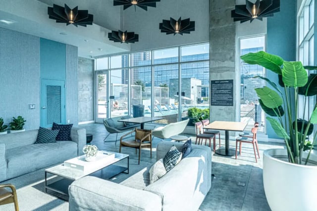 Modern lounge area with couches and tables living room at The Connector Apartments in Atlanta Student Accommodation