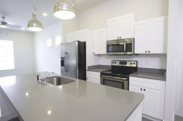 Kitchen island stainless steel refrigerator stove kitchen. at The Highlands in Reno Student Accommodation