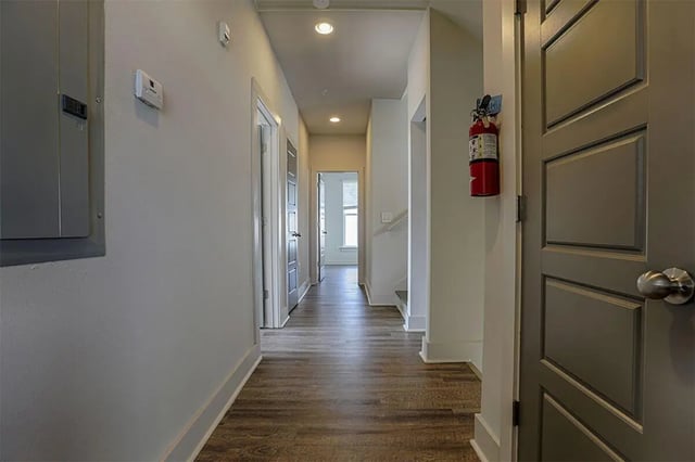 Hallway with doors and fire extinguisher Hallway at The Highlands in Reno Student Accommodation