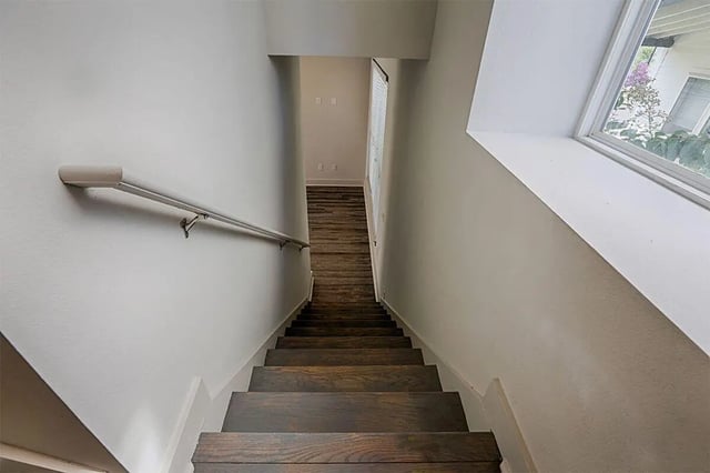 Wooden staircase with handrail and window view staircase at The Highlands in Reno Student Accommodation