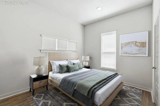 Bed nightstands lamps artwork and bedding bedroom at The Highlands in Reno Student Accommodation