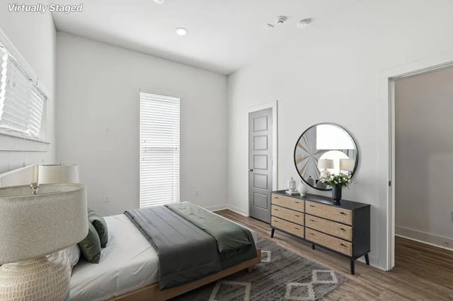 Bed with dresser mirror and door Bedroom at The Highlands in Reno Student Accommodation