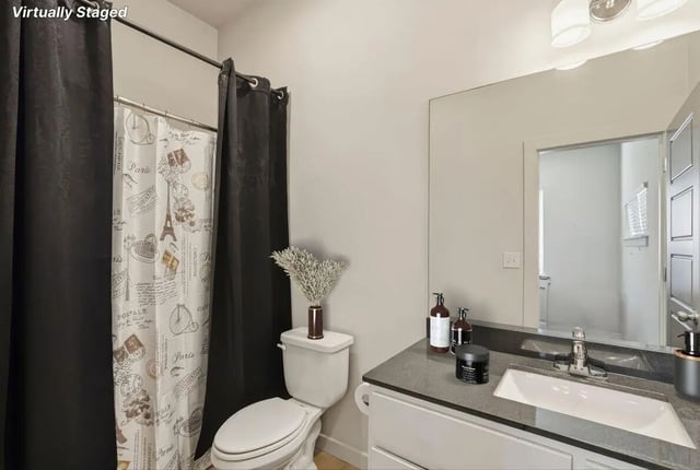 Toilet sink shower curtain and mirror Bathroom at The Highlands in Reno Student Accommodation