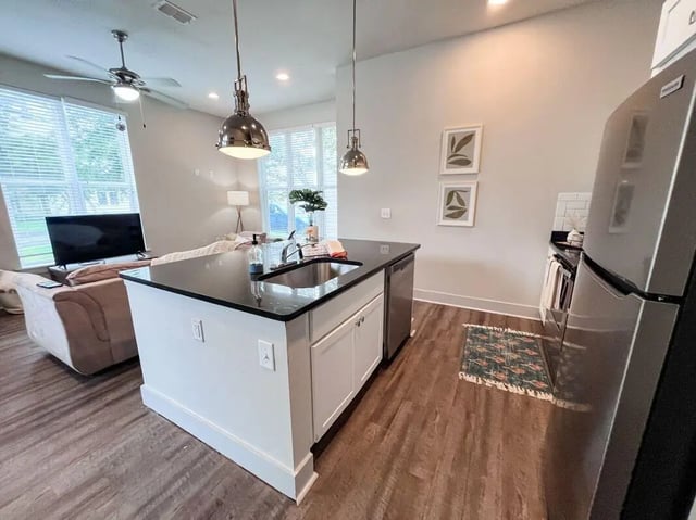 Island sink dishwasher refrigerator kitchen living area at The Highlands in Reno Student Accommodation