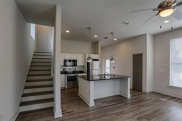 Stairs kitchen island and stainless steel appliances kitchen at The Highlands in Reno Student Accommodation
