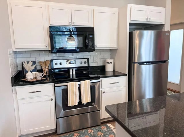 Microwave stove refrigerator and cabinets kitchen at The Highlands in Reno Student Accommodation