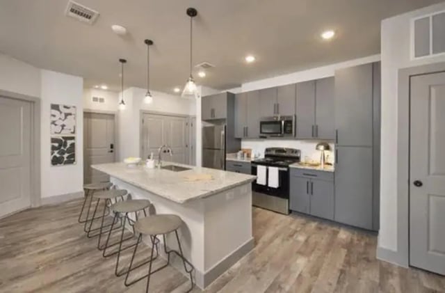 Island with stools grey cabinets stove kitchen at The Wyatt in Lexington Student Accommodation