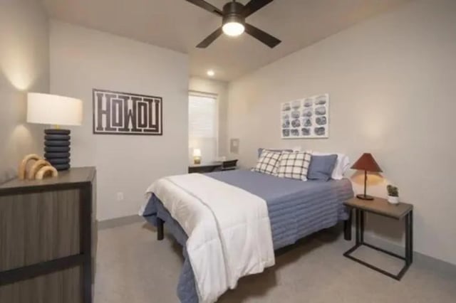 Bed with blue comforter pillows dresser lamp and art bedroom at The Wyatt in Lexington Student Accommodation