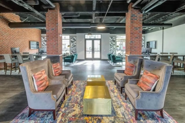 Chairs with pillows and gold tables living room at Proximity At 10th in Greenville Student Accommodation
