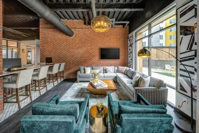 Sectional sofa and chairs with coffee table living room at Proximity At 10th in Greenville Student Accommodation