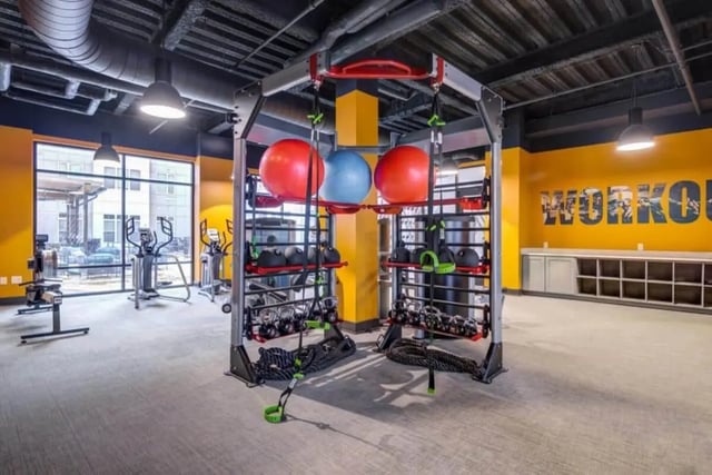 Gym equipment with workout sign gym at Proximity At 10th in Greenville Student Accommodation