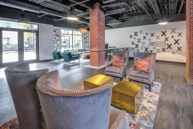 Velvet chairs gold tables decorative wall living room at Proximity At 10th in Greenville Student Accommodation