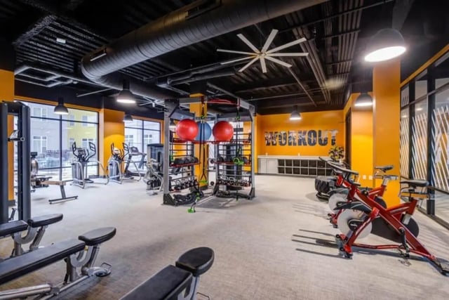 Gym equipment with workout sign and exercise bikes Gym at Proximity At 10th in Greenville Student Accommodation