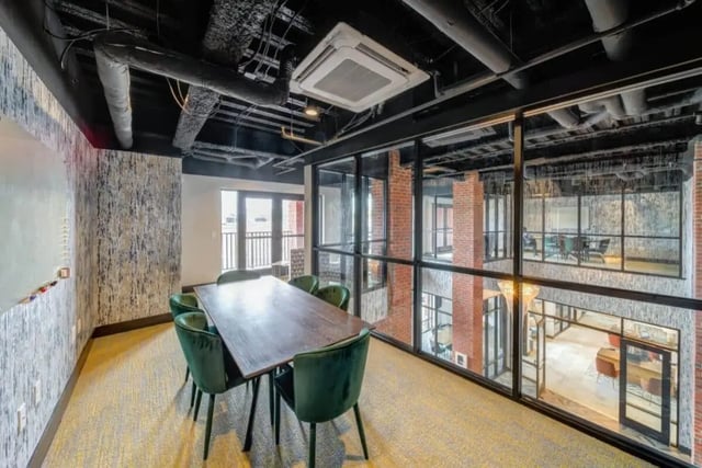 Dining table with chairs and whiteboard study area at Proximity At 10th in Greenville Student Accommodation