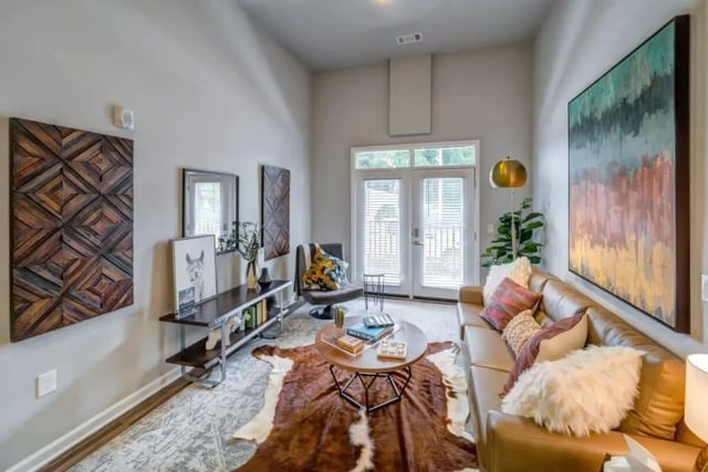 Leather sofa coffee table cowhide rug living room at Proximity At 10th in Greenville Student Accommodation