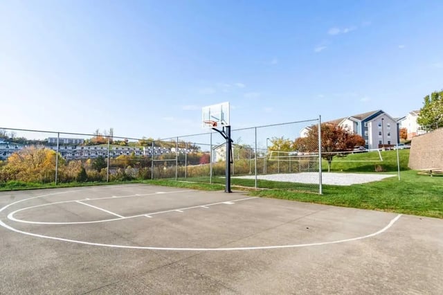 Basketball court with volleyball area exterior at West Run Morgantown in Morgantown Student Accommodation